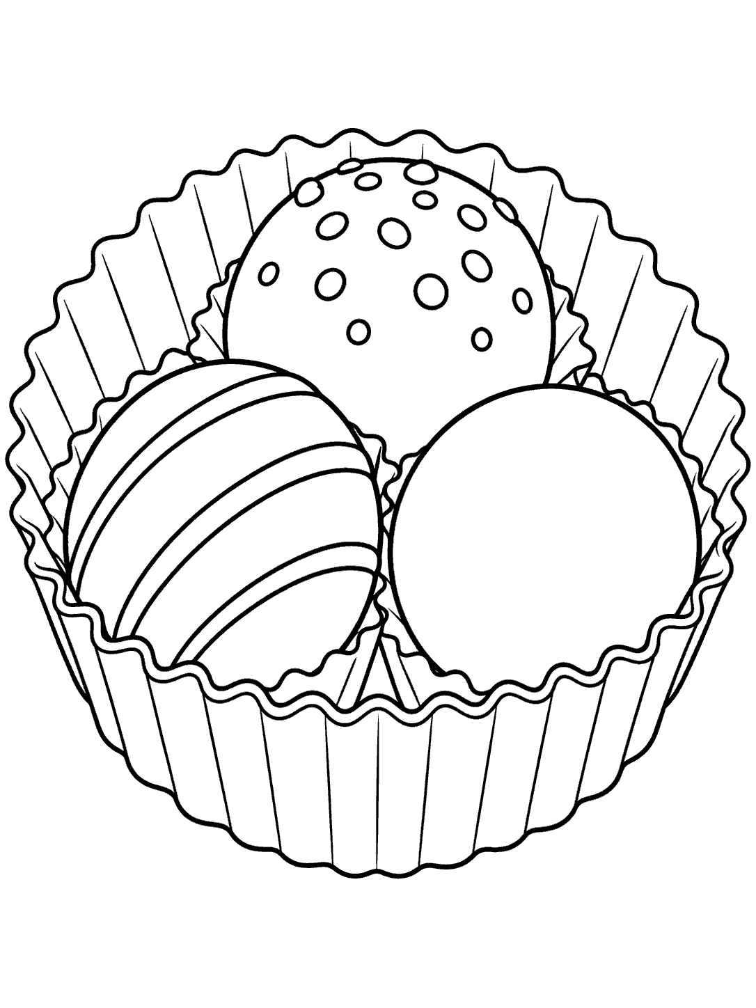 Three chocolate truffles in a fluted paper cup: one dotted, one striped, and one smooth.